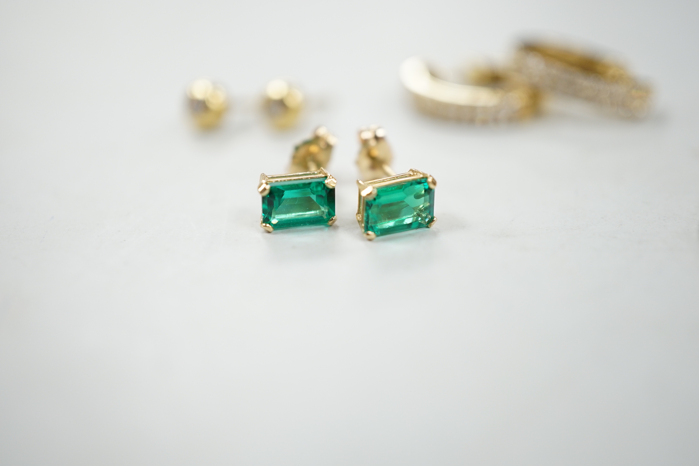 A modern pair of 18ct gold and collet set diamond ear studs, 5mm, two pairs of 9ct earrings (gross 4.5 grams) and a pair of 14k and green stone set ear studs.